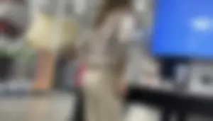 Plus Face shot - Gorgeous AT&T babe in beige pants  touching her ass with long red nails