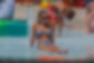 Sexy blonde babe at the pool with nice tits