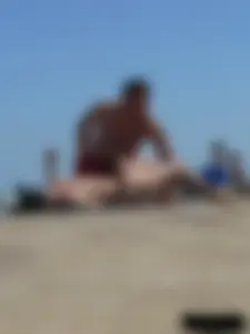 Purple thong topless lady on the beach gets oiled up by her husband