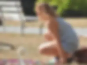 Lady at the park stripping down to her bikini to lay out