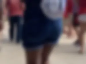 Bunch of girls in various outfits at a Cardinals baseball game