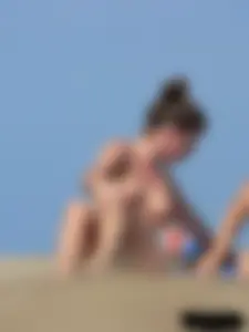 Sexy babe with a nice body topless and in a thong on the beach