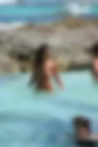 Nude beach ladies in the water showing their tits