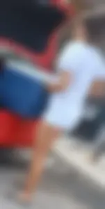 Young Candid Girl in White Shorts Loading Stuff to a Car Legs Closeups