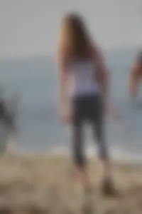Skinny blonde on the beach in tight grey leggings