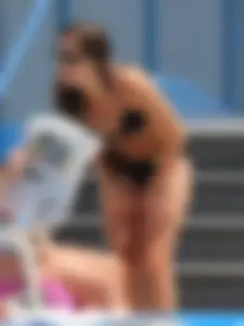 Sexy girl at the pool in a black bikini with nice body