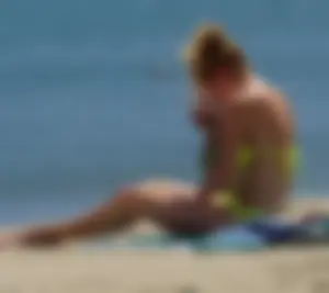 Sexy ass blonde milf on the beach in a thong with cameltoe and bending over