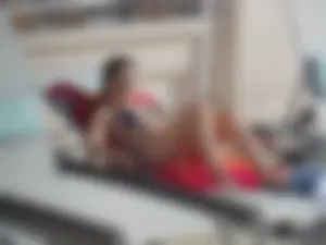 Sexy ass brunette sunbathing by the pool in thong bikini