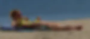 Sexy ass blonde milf on the beach in a thong with cameltoe and bending over