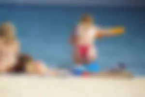 Hot blonde with a slammin body in red thong bikini on the beach