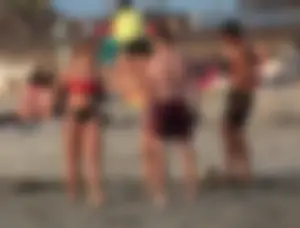 Thick white girls ass in a black thong bikini at the beach