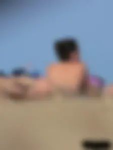 Sexy babe with a nice body topless and in a thong on the beach
