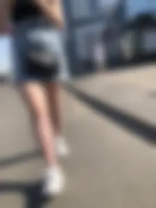 A very cute street candid girl wearing a denim fringed skirt passing by, great legs