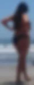 Thick brunette beach babe booty in a little black bikini