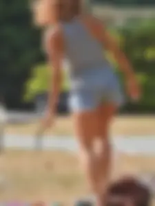 Lady at the park stripping down to her bikini to lay out