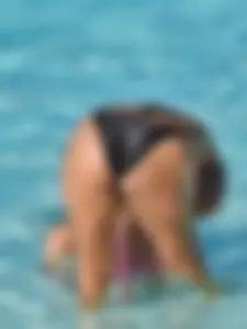 Sexy milf with a nice mom bod in a bikini in the pool