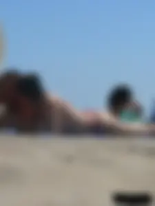Purple thong topless lady on the beach gets oiled up by her husband