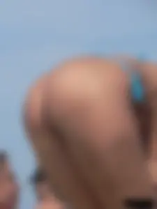 Sexy lady on the beach in a blue thong bikini
