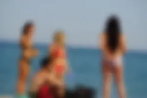 Hot blonde with a slammin body in red thong bikini on the beach