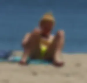 Sexy ass blonde milf on the beach in a thong with cameltoe and bending over