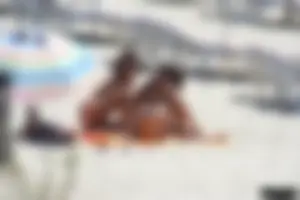 Topless milf and her topless daughter on the beach