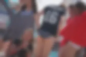 A group of teens in bikinis on the beach