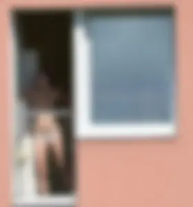 Peeping Tom pics of a topless girl in her house with nice tits