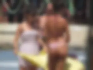 Girl with a great ass in thong bikini on the beach