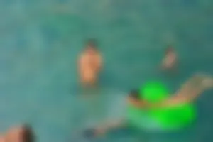 FKK Nudists playing in the water with floater