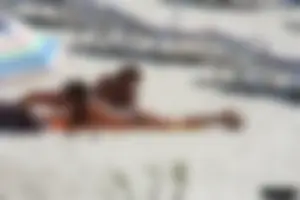 Topless milf and her topless daughter on the beach