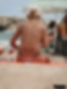 Tattooed blonde with big tits topless and in thong