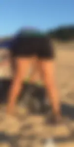 Chubby mature in spandex shorts bending over at the beach