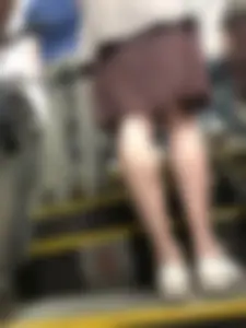Thin Legs in a Skirt on a Subway Escalator Closeup Photos