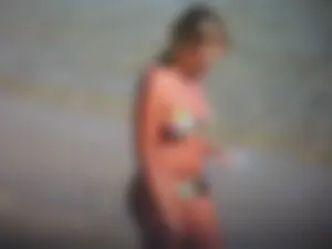 Blonde milf on the beach in her bikini