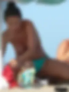 Bunch of sexy babes on the beach topless and in thong bikinis
