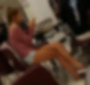 Teen in mini shorts sitting at the desk