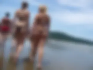 Two nice asses walking on the beach in black thong bikinis
