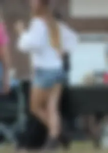 Hippie type dressed girl in denim shorts with a nice ass