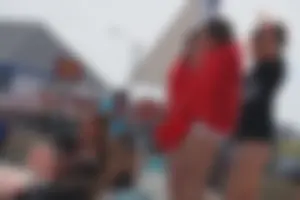 A group of teens in bikinis on the beach