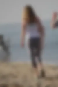 Skinny blonde on the beach in tight grey leggings