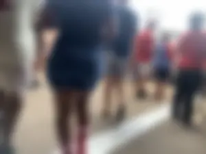 Bunch of girls in various outfits at a Cardinals baseball game