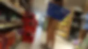 Girl shopping in short denim shorts showing some cheek