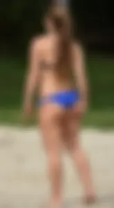 Cute girl playing volleyball in her little bikini