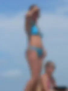 Sexy lady on the beach in a blue thong bikini