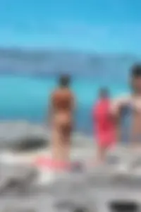 Older lady on a nude beach showing her body