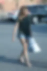 Cutie walking in the parking lot in jean shorts