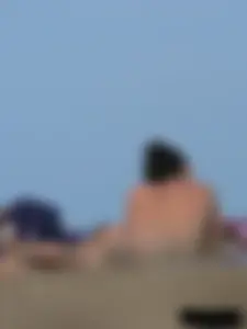 Sexy babe with a nice body topless and in a thong on the beach