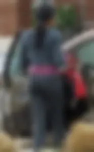Ebony babe getting into her car with a great ass in grey leggings