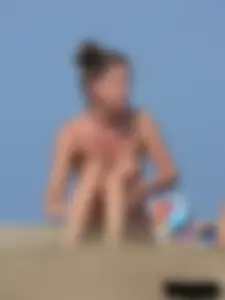 Sexy babe with a nice body topless and in a thong on the beach
