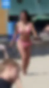 Sexy brunette on the beach in a bikini with great tits